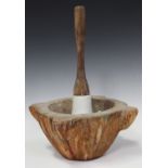 An early 20th century carved marble and wooden handled pestle and mortar, the exterior of the mortar