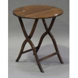 A 19th century rosewood circular folding coaching table, height 52cm, diameter 58cm (repairs).