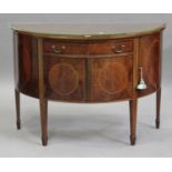 A 20th century George III style mahogany demi-lune sideboard, fitted with a drawer and cupboards, on