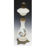 An early 20th century opaline glass and brass mounted table oil lamp, the body with a transfer