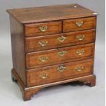 A small George II oak and mahogany crossbanded chest of two short and three long drawers, on