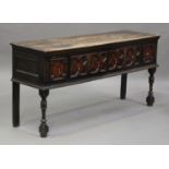 An early 18th century oak dresser base, fitted with four drawers with geometric mouldings, on turned