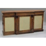 A Regency rosewood breakfront cabinet, the top with a moulded edge above cupboards enclosed by three