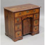 A late 19th/early 20th century George I style walnut kneehole desk, the crossbanded top above