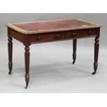 A Victorian mahogany writing table by Edwards & Roberts, fitted with two frieze drawers, on turned
