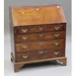 A George III oak bureau, the fall flap above four long drawers, raised on bracket feet, height