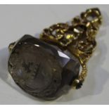 A late 18th/early 19th century gold and citrine triple sided rotating fob seal, the scrollwork mount