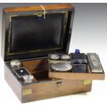 A late Victorian walnut and brass bound travelling vanity box, the compartmentalized interior fitted