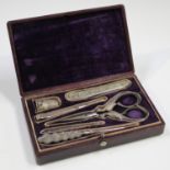 A mid-19th century leather étui case, the hinged lid enclosing a set of silver and steel