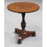 A Victorian mahogany circular wine table, on a turned baluster column and triform base with bun