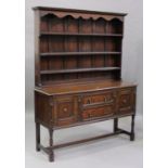 A 20th century Jacobean Revival oak dresser, the shelf back above two drawers flanked by