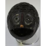 A 19th century Mexican carved coconut bugbear, one end typically modelled as a mask with gaping