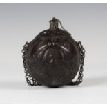 An early 19th century finely carved coconut bugbear powder flask of Napoleonic interest, one end