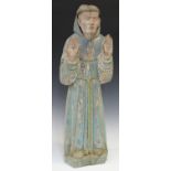 A carved wooden figure of a Franciscan monk, possibly 18th century, modelled with both hands