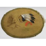 An early 20th century Canadian painted circular leather panel, depicting the portrait of a Native