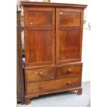 A Victorian figured mahogany linen press, the dentil moulded pediment above a pair of panel doors