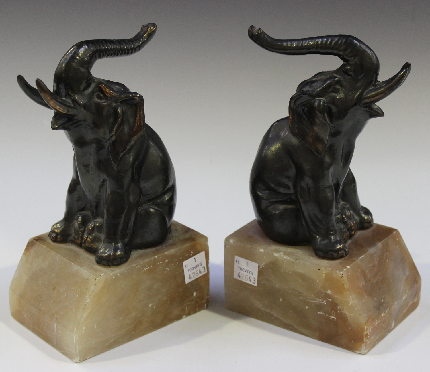 A pair of French Art Deco anodized cast spelter and pink toned onyx bookends, each modelled in the - Image 3 of 3