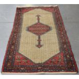 A Hamadan rug, North-west Persia, early 20th century, the ivory lattice field with a pole medallion,