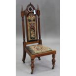 A late Victorian Gothic Revival rosewood framed side chair, the seat and back inset with original