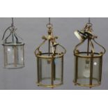 A pair of 20th century brass framed hanging hall lanterns, height 48cm (one panel lacking), together