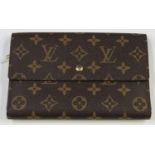A Louis Vuitton monogram canvas travel wallet, the interior with zip compartment, card slots and