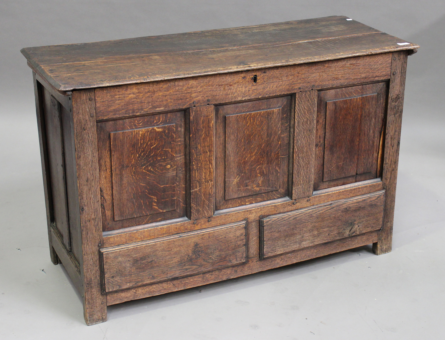 An 18th century oak panelled coffer, the hinged lid raised on stile supports, height 75cm, width