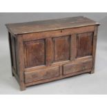 An 18th century oak panelled coffer, the hinged lid raised on stile supports, height 75cm, width