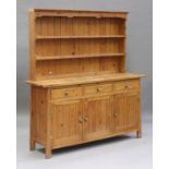 A 20th century pine dresser, the shelf back above three drawers and cupboards, on block legs, height