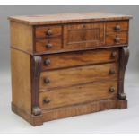 A William IV mahogany chest of five short and three long drawers, flanked by scroll pilasters, on