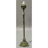 An Edwardian brass telescopic lamp standard with a reeded stem and circular base, on three tab feet,