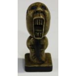 A small South-east Asian carved and stained soapstone figure with large open mouth and long beard,