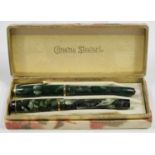 A Conway Stewart 'Dinkie' 550 fountain pen with green and brown marbled plastic case, length 10.5cm,