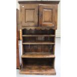 A 17th century and later oak hall cupboard dresser, the moulded pediment above a pair of panelled