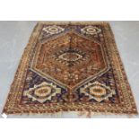 A Shiraz rug, South-west Persia, early 20th century, the red field with a lozenge medallion,