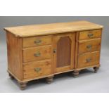 A Victorian pine dresser base, fitted with six drawers and central cupboard, on turned feet,