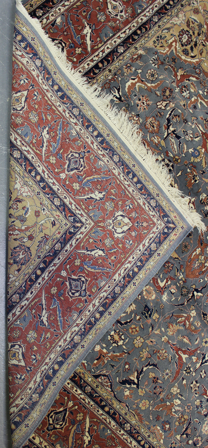 A fine Pakistan carpet, mid/late 20th century, the grey field with a floral medallion, supported - Image 2 of 2