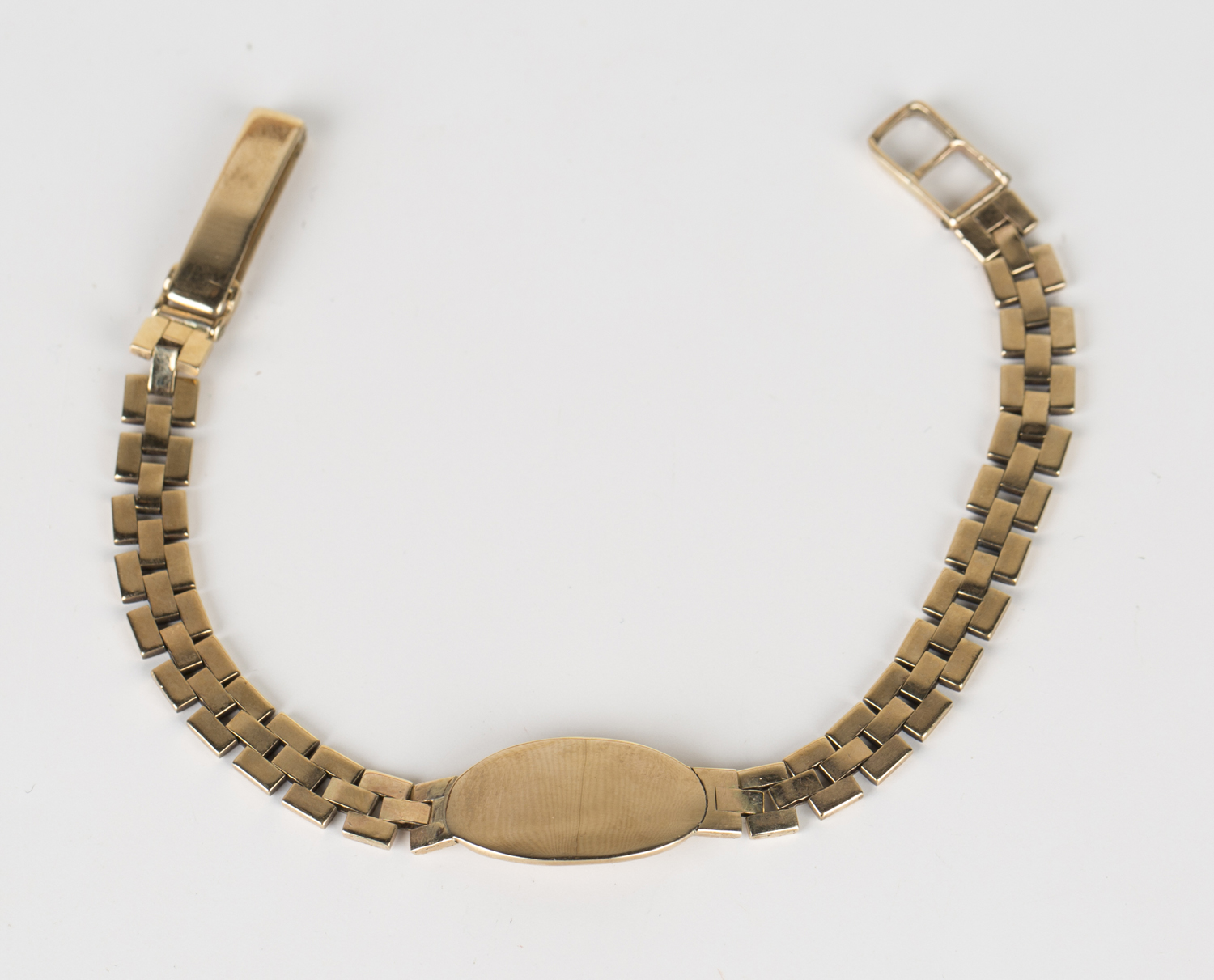 A 9ct gold identity bracelet with a fold-over clasp, London 1956, length 17.5cm.Buyer’s Premium 29.