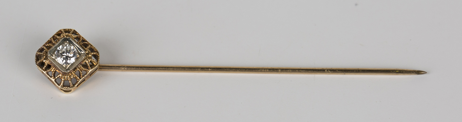 A gold and diamond single stone stickpin, mounted with a circular cut diamond within a pierced