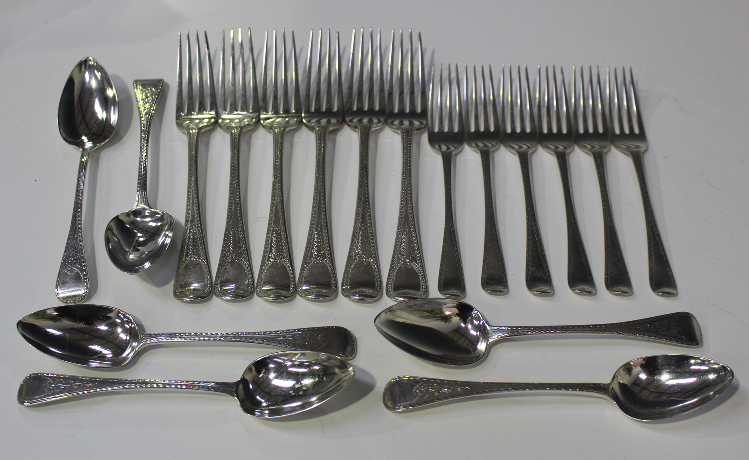 A set of six George III silver Old English pattern tableforks with bright-cut engaved decoration,