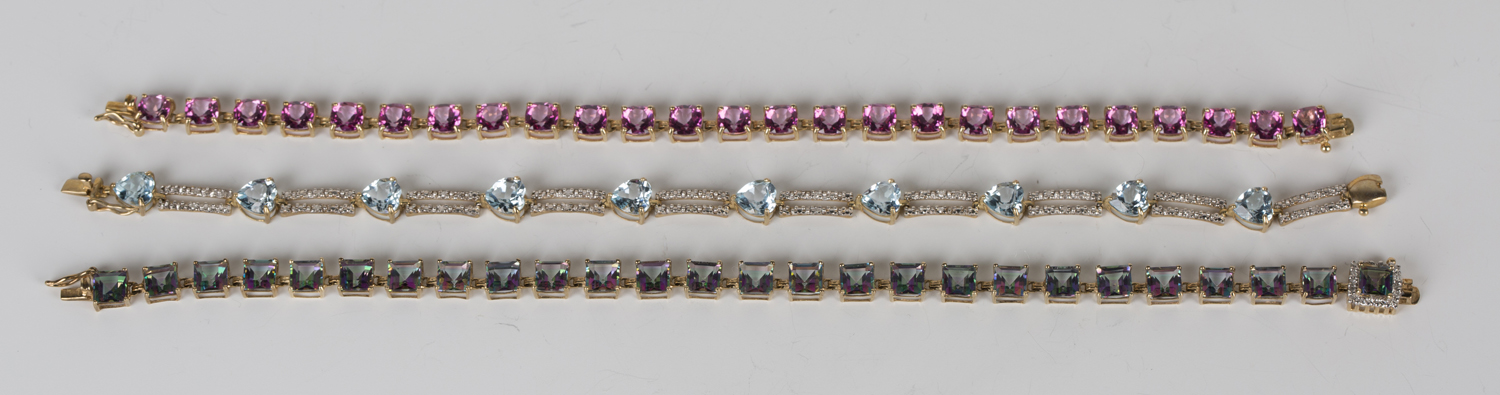 A 9ct gold, harlequin coloured topaz and diamond bracelet, designed as a row of square cut harlequin