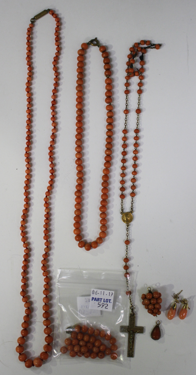 Two single row necklaces of coral beads, lengths 61cm and 35cm, a coral bead pendant, length 1.