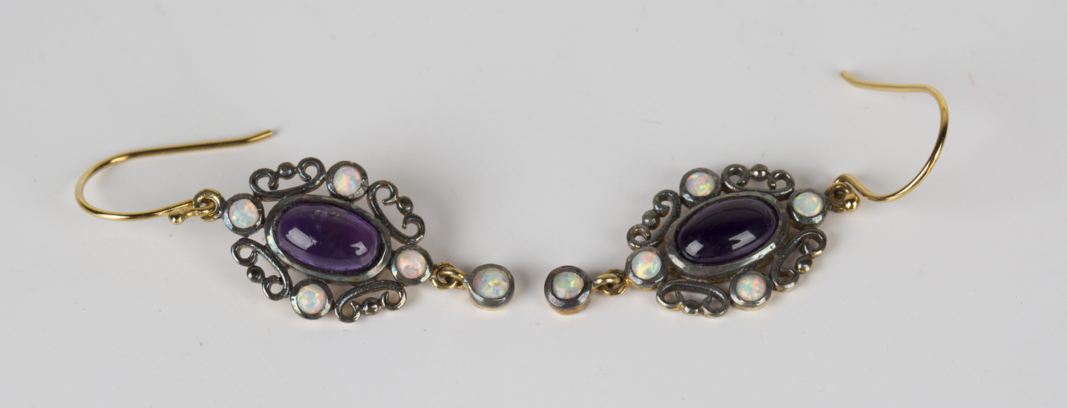 A pair of amethyst and opal pendant earrings, mounted with an oval cabochon amethyst within a scroll