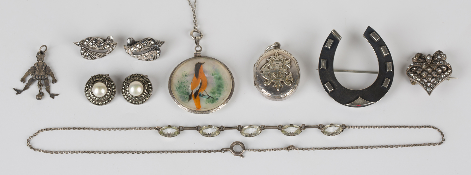 A group of mostly silver mounted jewellery, comprising two pairs of marcasite earclips, an oval