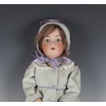 An Armand Marseille bisque head doll, impressed 'A8M 390', with later brown wig, sleeping blue eyes,