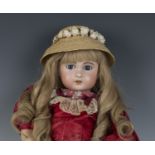 A Jumeau bisque head doll, impressed '1907', with blonde wig, fixed brown eyes, pierced ears,