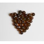 Thirty amber glass mica marbles (some playwear and light chips).Buyer’s Premium 29.4% (including VAT