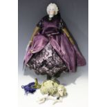 A Victorian clockwork automaton doll with painted bisque head and shoulders, kid leather arms and