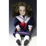 An Armand Marseille bisque head doll, impressed '390n DRGM 246/1 A9M', with later brown wig,