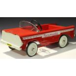 A Tri-ang Bermuda treadle drive pedal car of steel construction, finished in red and white, length