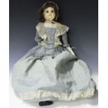 A mid-19th century wax-over-composition doll with brown hair, fixed blue eyes, painted eyebrows